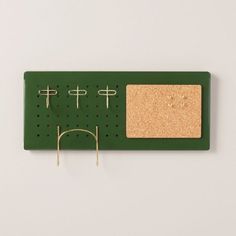 a pair of glasses hanging on a pegboard with corks attached to the board