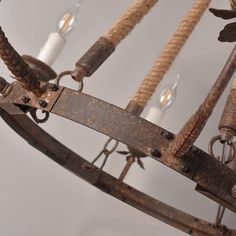 an old metal chandelier with rope and lights