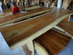 a man sitting at a table made out of wooden planks