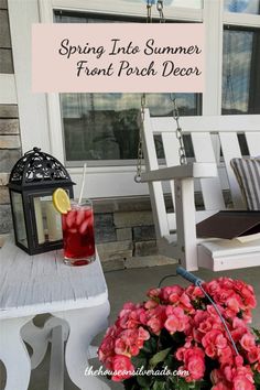 a porch swing with flowers and a drink on the table next to it, that says spring into summer front porch decor