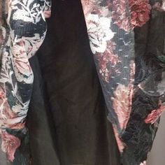 a woman's black and pink floral print jacket