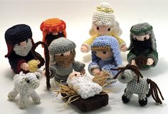 a group of crocheted nativity figurines sitting next to each other