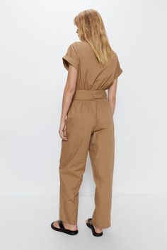 Collared utility-inspired jumpsuit with a flattering tie-up waist
Short sleeves and a zip-front fastening for easy on and off
Petite fit with tapered legs for a sleek, feminine silhouette
Crafted from a lightweight yet durable woven cotton fabric
Functional patch pockets add a utilitarian edge
This petite utility boilersuit from Warehouse effortlessly combines style and comfort. The collared design and tie-up waist create a flattering fit, while the tapered legs and lightweight cotton fabric offer unrestricted movement. Dress it up with heeled sandals for a chic evening look or pair with trainers for a casual day out. Its versatility makes it an ideal choice for social gatherings, casual events, or weekend errand runs. Petite Jumpsuit, Boiler Suit, Oasis Fashion, Feminine Silhouette, Petite Outfits, Linen Dresses, Woven Cotton, Fashion Face, Heeled Sandals