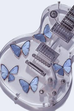 an electric guitar with blue butterflies on it