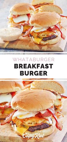 breakfast burgers with bacon, cheese and eggs on wooden cutting board in front of white background