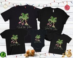 three t - shirts with palm trees and flamingos on them, one is black