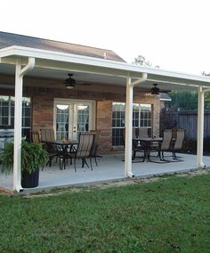 a covered patio with chairs and tables on it