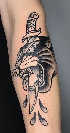 a black and white tattoo of a cat with a hat on it's head