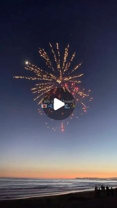 fireworks on the beach at night time with people watching from the shore and in the distance