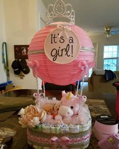 it's a girl basket filled with stuffed animals and princess tiara on top