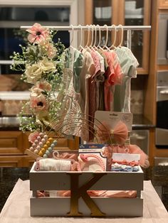 an assortment of baby clothes on display in a kitchen