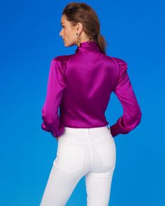 Our bestselling Aurelie Pussybow Blouse is a bewitchingly feminine and powerful blouse–equally at home in the boardroom or an evening party. We blended a color that perfect to wear year-round: rich for fall and holiday abut bright for warmer months. The rich fuchsia purple is both powerful and understated. A satin finish lends a subtle sheen and polish. The fabric has stretch for comfort. May be worn as a stand alone or as the perfect layering piece underneath a blazer. • 98% polyester satin, 2% Fitted Purple Chic Blouse, Chic Fitted Purple Blouse, Elegant Purple Shirt For Party, Elegant Purple Party Shirt, Fitted Feminine Purple Blouse, Feminine Purple Party Tops, Pussybow Blouse, Blouse Size Chart, Casual Luxe