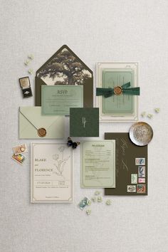 the wedding stationery is laid out on top of each other, including an envelope