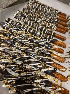 chocolate covered donuts with sprinkles are lined up on a tray