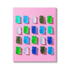 gummy bears are arranged on a pink background, with green and blue gummy bears in the middle