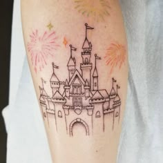 a tattoo with a castle and fireworks on it