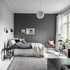 a bedroom with gray walls and white carpeted flooring in the middle of it