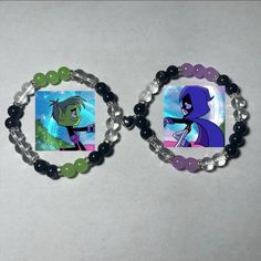 two bracelets with cartoon characters on them, one is green and the other is purple