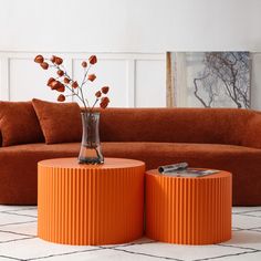 an orange couch and two tables in a living room