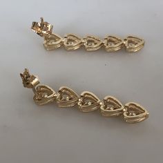 These are adorable heart drop earrings with diamonds set in each little heart. They have a sturdy pushback closing and are not super heavy on the ear. The are slightly over 1 inch in length. They weigh 4.16 grams total weight. The diamonds weight approximately.08ct total. With any pre-owned/Vintage/Antique items, it is common to have some wear, As we inspect each piece of our jewelry, we make sure the wear and tear is acceptable within industry standards FOLLOW US TO SEE MORE PHOTOS OF OUR JEWEL Gold Heart Earrings With Prong Setting For Wedding, Fine Jewelry Heart Dangle Earrings For Anniversary, Gold Heart-shaped Diamond Earrings For Wedding, Gold Dangle Heart Earrings With Cubic Zirconia, Gold Cubic Zirconia Dangle Heart Earrings, Gold Cubic Zirconia Heart Dangle Earrings, Elegant Gold Diamond Earrings For Valentine's Day, Gold Heart Earrings With Prong Setting, Gold Heart Earrings With Prong Setting For Valentine's Day