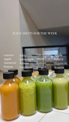 seven different types of smoothies in bottles lined up on a counter top with the words juice shots for the week written below