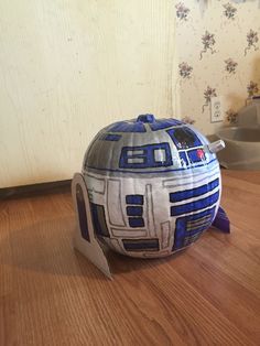 a star wars helmet sitting on top of a wooden table