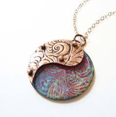 Yin Yang Enamel Necklace, Riveted Paisley, Copper Pendant, Artisan Jewelry, Mixed Media, 3D Layered, Hand Enameled Jewelry, Boho Necklace The top layer of this pendant is embossed with a geometric design and hand-sawed in a paisley shape from copper sheet, and then oxidized to highlight the pattern. The top layer is then riveted atop tiny tubes over a hand-enameled abstract floral pattern on a copper base plate in shades of blue, red, and yellow. The stacked and riveted layers create a 3-D effec Rivet Jewelry, Enameled Jewelry, Clay Pendants, Etched Copper, Copper Sheets, Enamel Necklaces, Polymer Clay Necklace, Clay Necklace, Copper Pendant