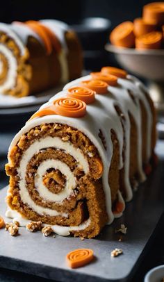 there is a cake roll with white frosting and orange candies