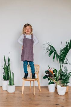 This minimalist Japanese-style apron doesn’t tie around the waist, but crosses in the back to stay put. Two roomy pockets and an effortless, drapey style make this linen apron the perfect accessory for little ones helping with tasks in the kitchen. Japanese Style Apron, Minimalist Japanese, Ethical Shopping, Kids Apron, Dusty Purple, Garden Studio, Kitchen Garden, Linen Apron, The Kitchen