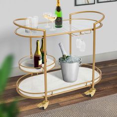 a gold bar cart with wine glasses and bottles