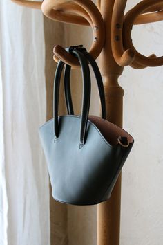 Genuine Mango Vegan leather bucket bag in deep evergreen.

This purse features a structured exterior body with zip closure cotton interior compartment.

Can be carried as a handbag or worn as a shoulder or crossbody with the included strap!

Like new condition. There is minor wear on d-ring hardware where the optional strap attaches. Modern Bucket Bag With Handles For Errands, Green Bucket Bag With Adjustable Strap And Top Handle, Green Bucket Shoulder Bag With Handle Drop, Modern Green Bucket Bag With Leather Handles, Green Bucket Bag With Detachable Handle, Modern Green Bucket Bag With Detachable Handle, Modern Satchel Bucket Bag, Bucket Shoulder Bag With Handle Drop For Errands, Green Bucket Satchel