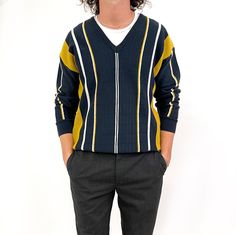 Cool, smart vintage Gabicci men's jumper in dark navy, mustard yellow and white vertical stripe design, with suede stripe appliqué. It is tightly knit, fairly lightweight and with a fun textured design. Perfect for wearing over a collared shirt, a plain T-shirt or simply on its own. Made in Italy by Gabicci. A popular brand amongst young men in the 80's. 30% wool, 70% acrylic. Medium size. Measurements when laid flat are: Pit to pit: 58cm Waist: 55cm  Waistband: 40cm Length: 68cm Great condition Long Sleeve Sweater With Contrast Stripes For Work, Long Sleeve Striped Sweater For Work, Classic Winter Tops With Contrast Stripes, Navy Top With Contrast Stripes For Fall, Fitted Striped V-neck Sweater, Winter Workwear Tops With Contrast Stripes, Navy Retro Top For Fall, Vertical Striped Sweater, Stripes Sweater