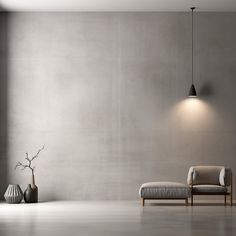 an empty room with a chair, vases and a lamp on the wall in front of it