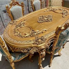 an ornately decorated dining table and chairs