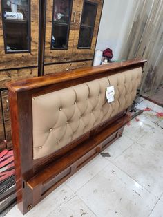 the headboard is made from wood and has buttons on it, along with other furniture