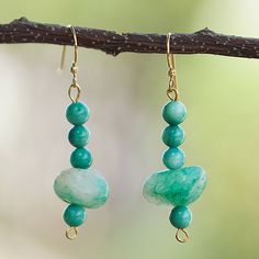 Turquoise hues will transport you to a paradisiac lagoon with a refreshing aura, all thanks to Victor Dushie's talented hands. The Ghanaian artisan uses recycled glass beads and agate chips, symbolizing vitality, to create these dangle earrings equipped with brass hooks, making them perfect for a fun outing with friends or loved ones. Handmade Turquoise Amazonite Earrings, Green Jade Earrings For Healing, Turquoise Jade Earrings With Natural Stones, Handmade Turquoise Jade Earrings, Green Jade Gemstone Bead Earrings, Green Jade Earrings With Gemstone Beads, Adjustable Green Beaded Earrings With Natural Stones, Adjustable Jade Beaded Dangle Earrings, Brass Hooks