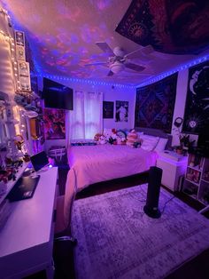 a bed room with a neatly made bed and lots of lights on the ceiling above it