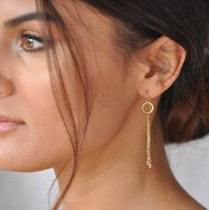 "These playful chain tassel earrings will make you stand out instantly. Four chains adorned with gold beads dangle from tiny hoops. Light weight and ultra comfortable. Sleek, sophisticated and a little flirty. Our gift to you 10% off your first purchase. Details here - http://eepurl.com/dpVPBz DETAILS Total earring length including ear wire is 2.5\" 14 k gold fill or sterling silver ear wires, chain and beads 24 k gold plate circles These earrings are sold as a pair All earrings are not returnab Delicate Long Drop Earrings With Dangling Beads, Dainty Linear Earrings With Delicate Chain, Chandelier Earrings With Adjustable Chain As Gift, Delicate Long Drop Jewelry With Dangling Beads, Gold Dangle Tassel Earrings For Wedding, Bohemian Dangle Jewelry With Delicate Chain, 14k Gold Filled Earrings With Delicate Chain For Wedding, Minimalist Everyday Jewelry With Dangling Beads, Delicate 14k Gold Filled Dangle Earrings