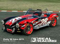 a red and black race car driving down a track with the words real racing on it