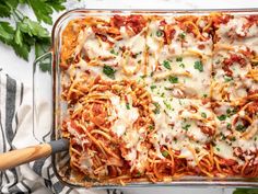 a casserole dish with meat, cheese and sauce