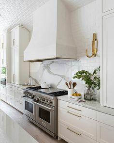 a kitchen with white cabinets and marble counter tops is featured on instagram for the homeownership