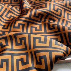 an orange and black pattern on a sheet