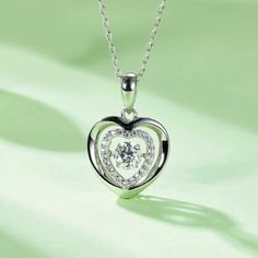 An eye-catching round moissanite dances with ease at the center of this appealing women's necklace, expressing your unstoppable love. Additional round gem set in sterling silver frame the center. Features Moissanite was originally found in meteorites(Chemical name: Silicon Carbide). It was first discovered in 1893, while a scientist was examining meteor samples from a crater in Arizona. After many years, the experts has been recreated moissanite in the laboratory, that make the gemstone with fri Double Heart Necklace, Women's Necklace, Silicon Carbide, Moissanite Necklace, Moissanite Jewelry, Round Moissanite, Double Heart, Timeless Jewelry, Silver Frame