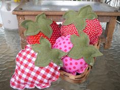 a basket filled with red and white polka dot covered strawberries on top of a table