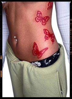 Red Butterfly Tattoos Inspiration Tattoo Ideas Red Butterfly, Red Butterfly Hip Tattoo, Red Butterfly Spine Tattoo, Red Rib Tattoos For Women, Red Butterfly Back Tattoo, Red Butterfly Tattoo Stomach, Butterfly Tattoo On Hip For Women, Red Ink Thigh Tattoos Women, Y2k Style Tattoo