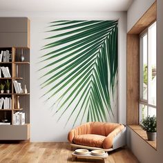 a living room with a palm leaf wall decal on the wall next to a chair