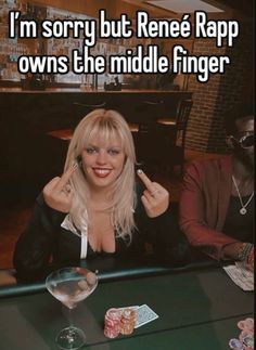 a woman sitting at a table with poker chips in front of her and the caption says, i'm sorry but renee rapp owns the middle finger