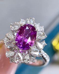 a close up of a ring with a large purple stone in it's center