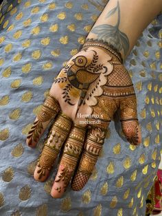 a woman's hand with henna tattoos on it