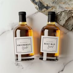 two bottles of groomsman spirit on a marble surface